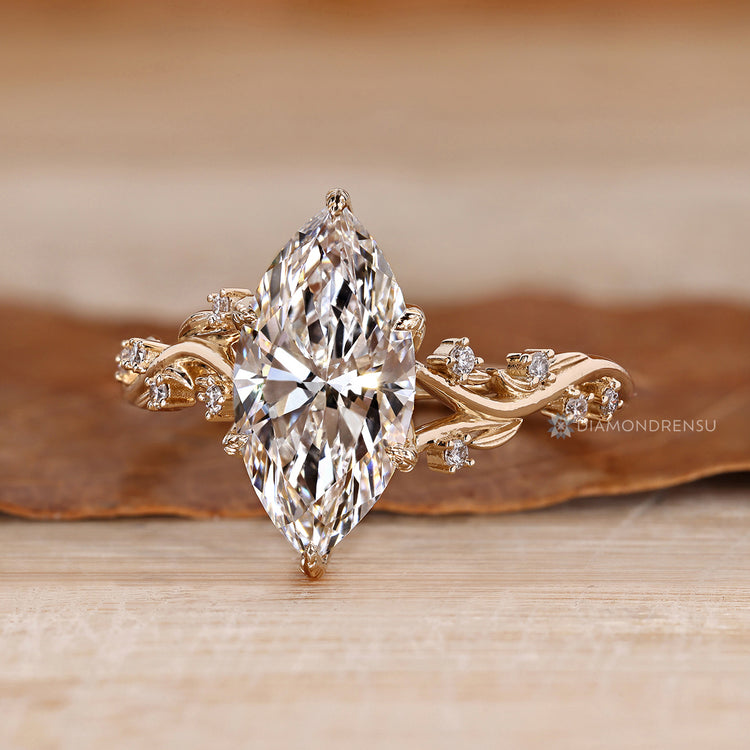 Marquise engagement ring with six leaf style prongs.