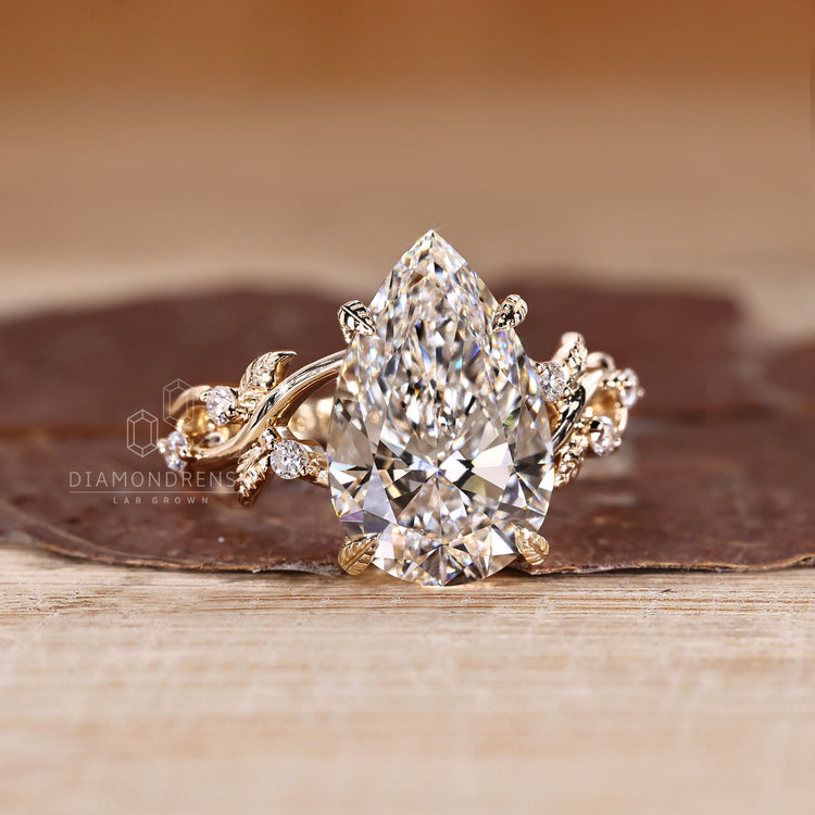 Pear diamond ring with round side stones handmade style.