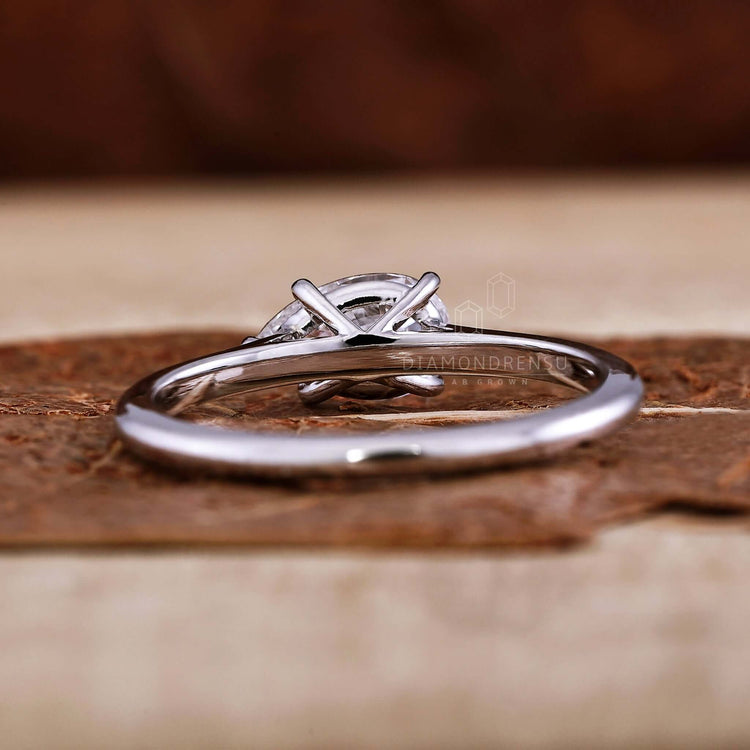 White gold engagement ring with a unique pear-shaped design
