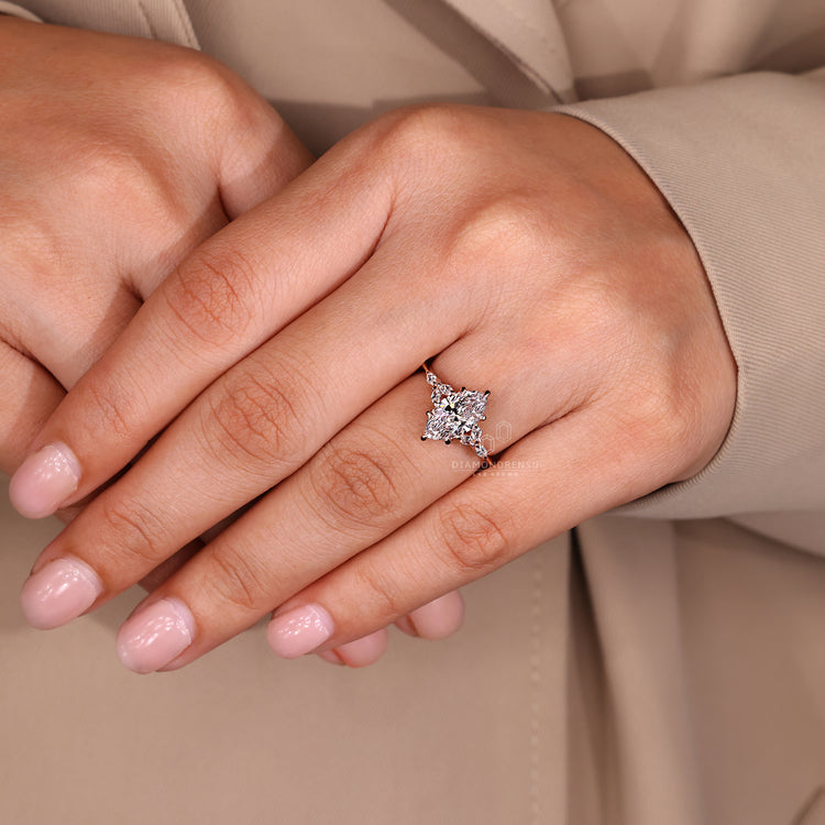 Lab grown marquise diamond ring with side stone detail.
