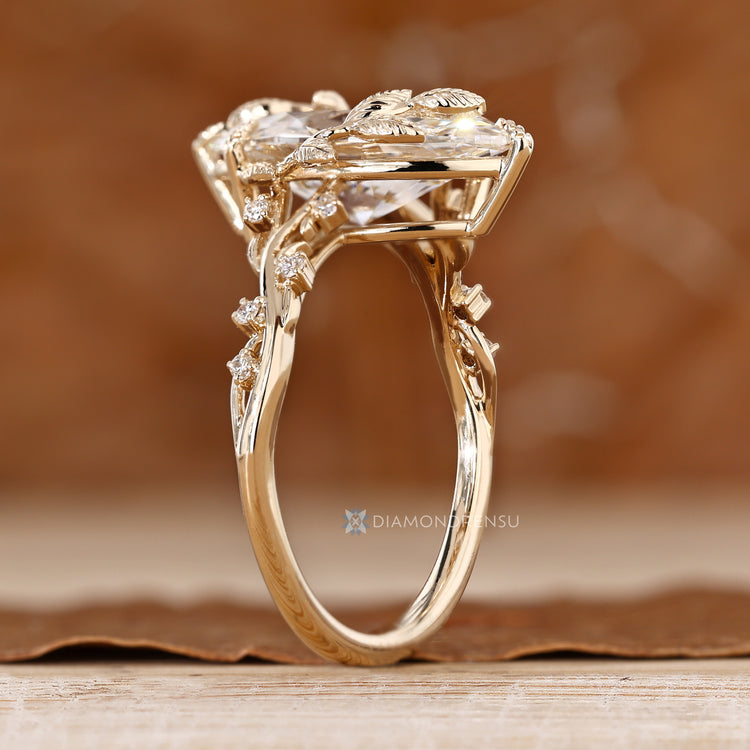 Nature inspired marquise ring with round side stone details.