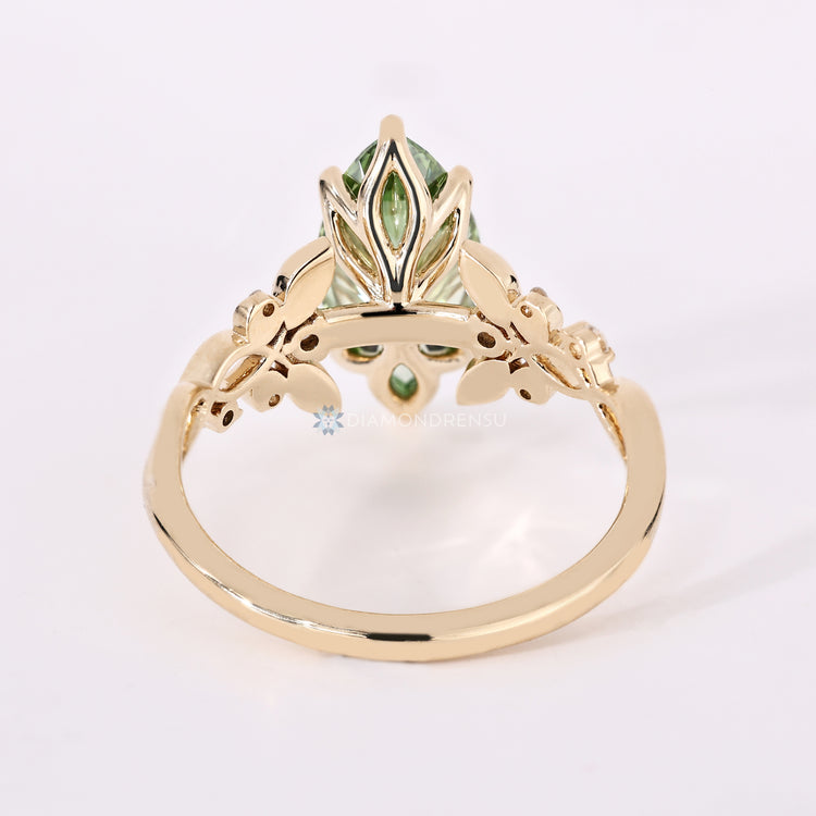 Marquise engagement ring with twisted shank and round diamonds.