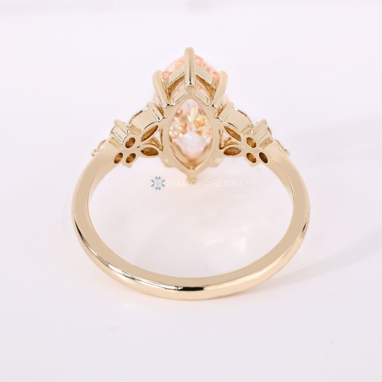 Cluster setting marquise ring with pink centre diamond.