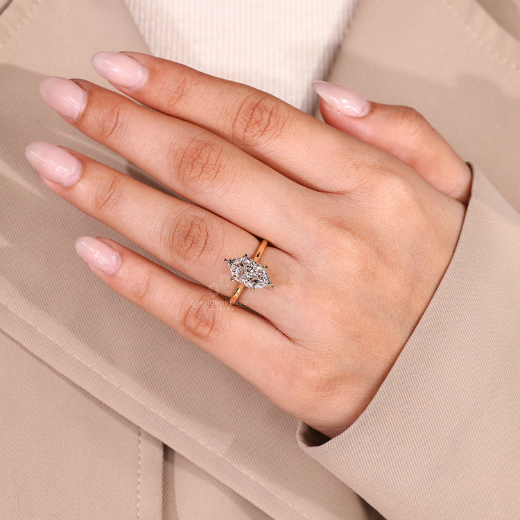 Handmade marquise diamond ring with six leaf prong setting.