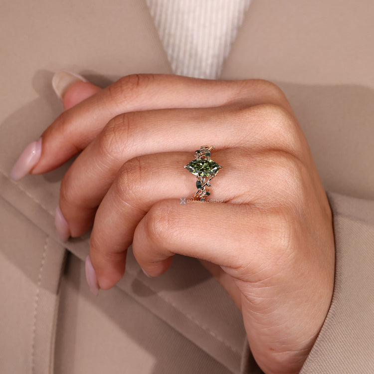 Marquise ring with round moss agate side stones.