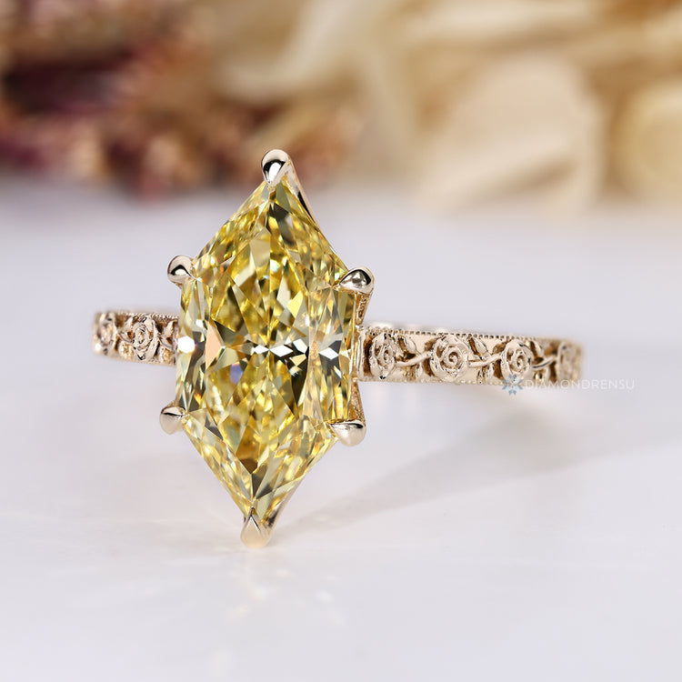 Yellow marquise diamond ring with six claw prong setting.