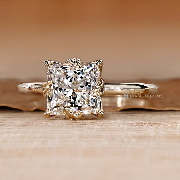 Princess cut engagement ring with nature inspired design.