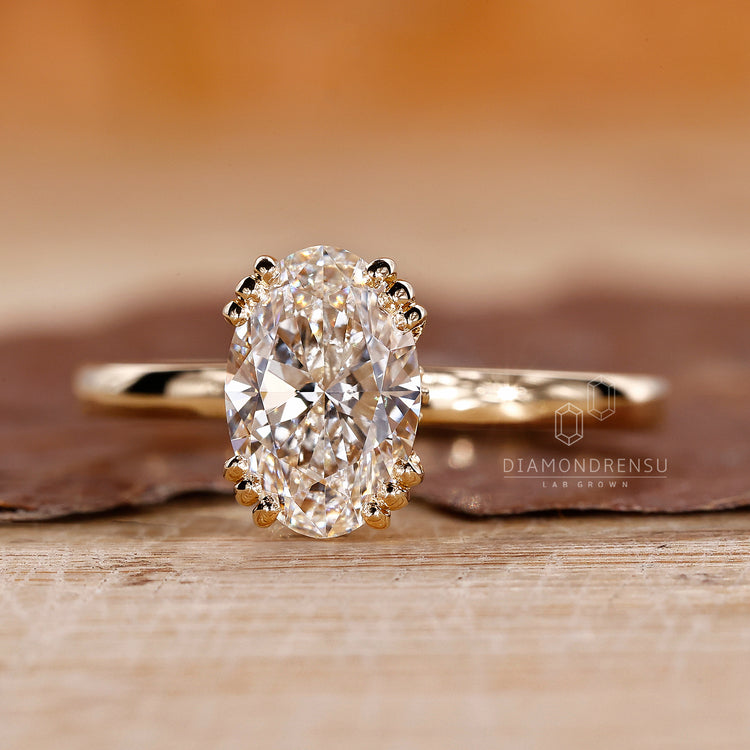 Oval lab diamond ring with hidden round cut diamonds.