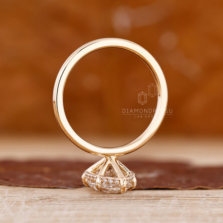 Diamondrensu pear ring with halo and solitaire setting.
