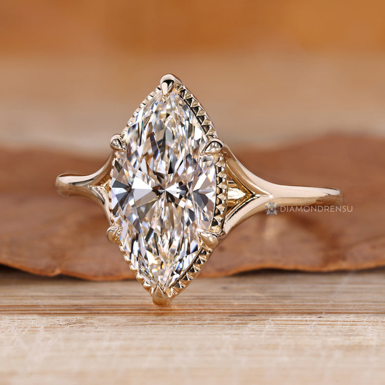 Marquise diamond ring with cathedral and split shank.