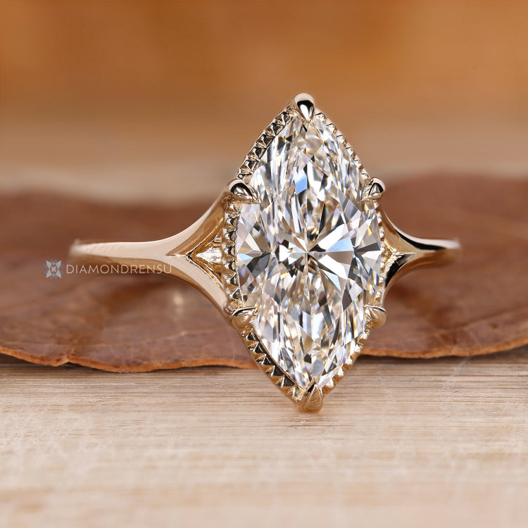 Lab grown marquise diamond ring with six claw prongs.