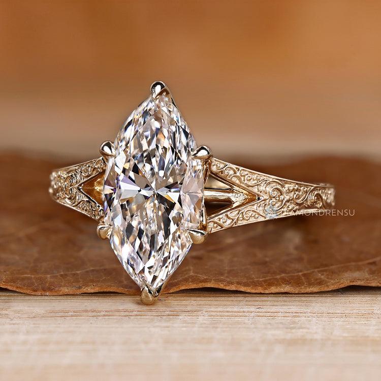 Marquise solitaire ring with cathedral setting and handmade finish.