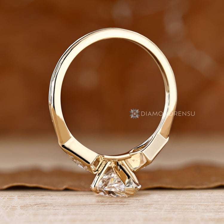 Bezel set Dutch marquise ring with kite side stone.