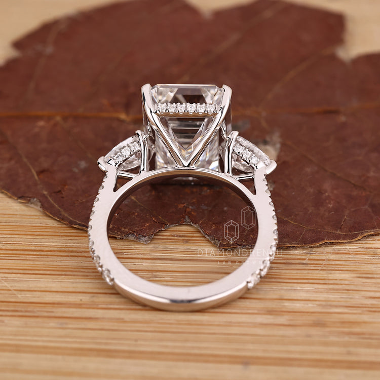 Emerald cut diamond ring in cathedral style setting.