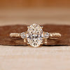 Oval cut lab grown diamond engagement ring with round sides.

