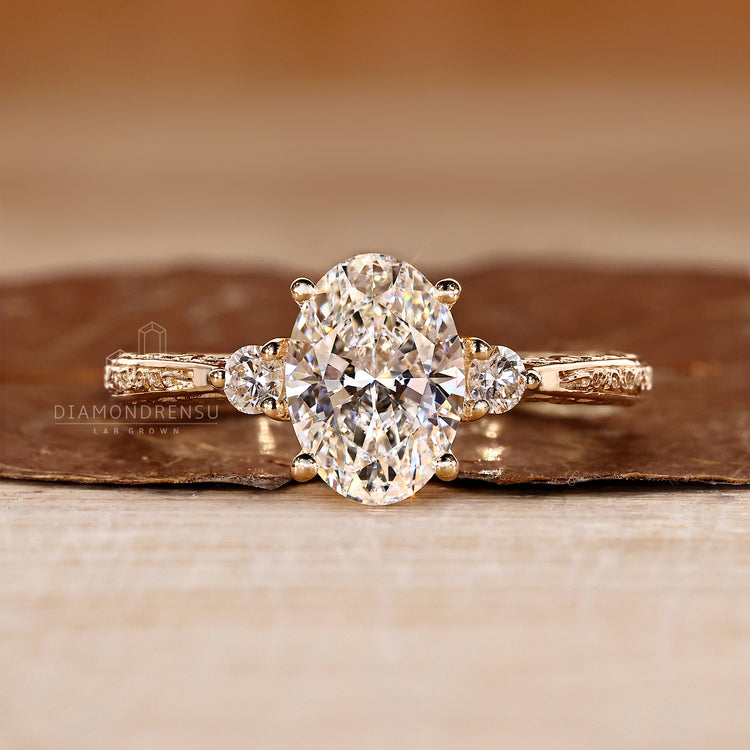 Oval cut lab grown diamond engagement ring with round sides.
