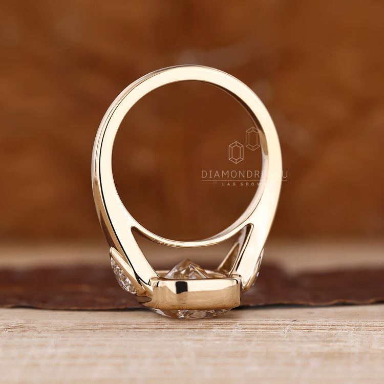 Cushion diamond ring with tapered band and side stones.
