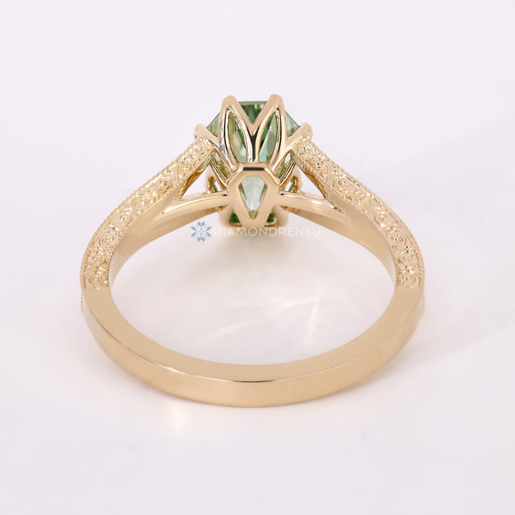 Handmade green diamond ring with six claw prongs.
