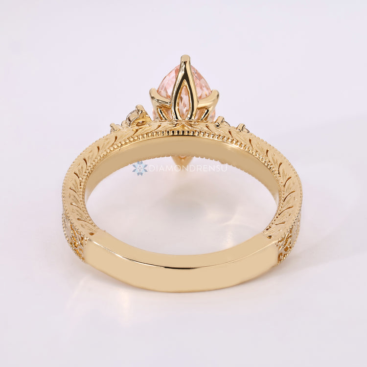 Marquise cut ring with round side stones and prongs.