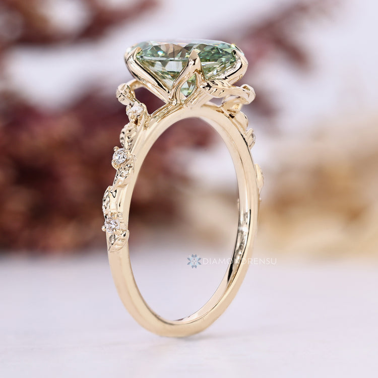 Green oval diamond ring with tulip setting.