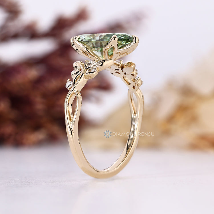 Marquise cut ring with vine motifs and round side stones.