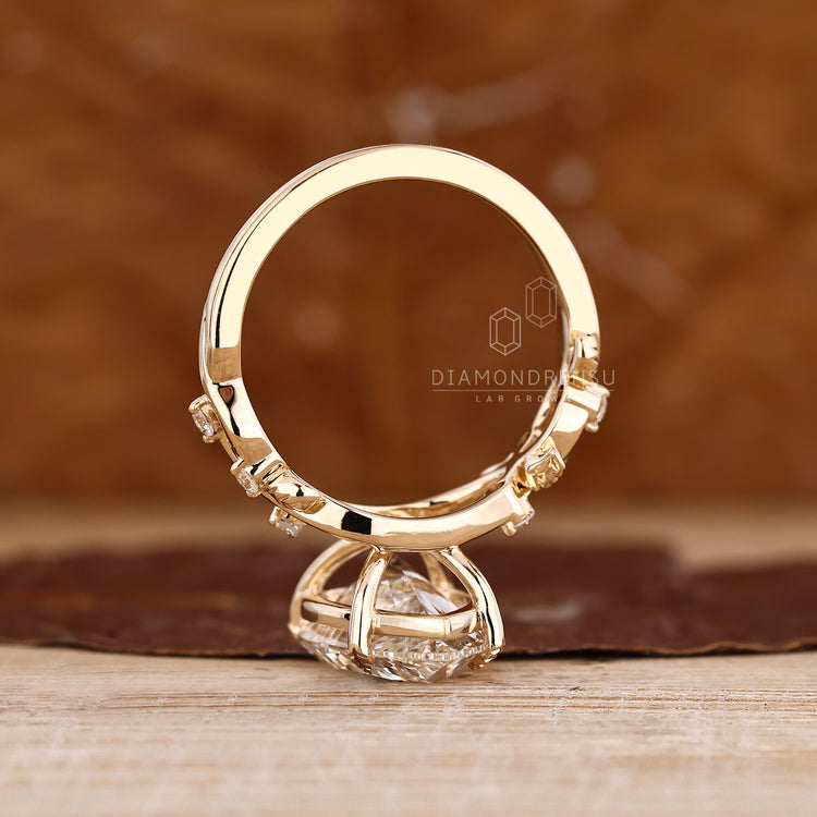 Cluster setting pear diamond ring with nature inspired design.