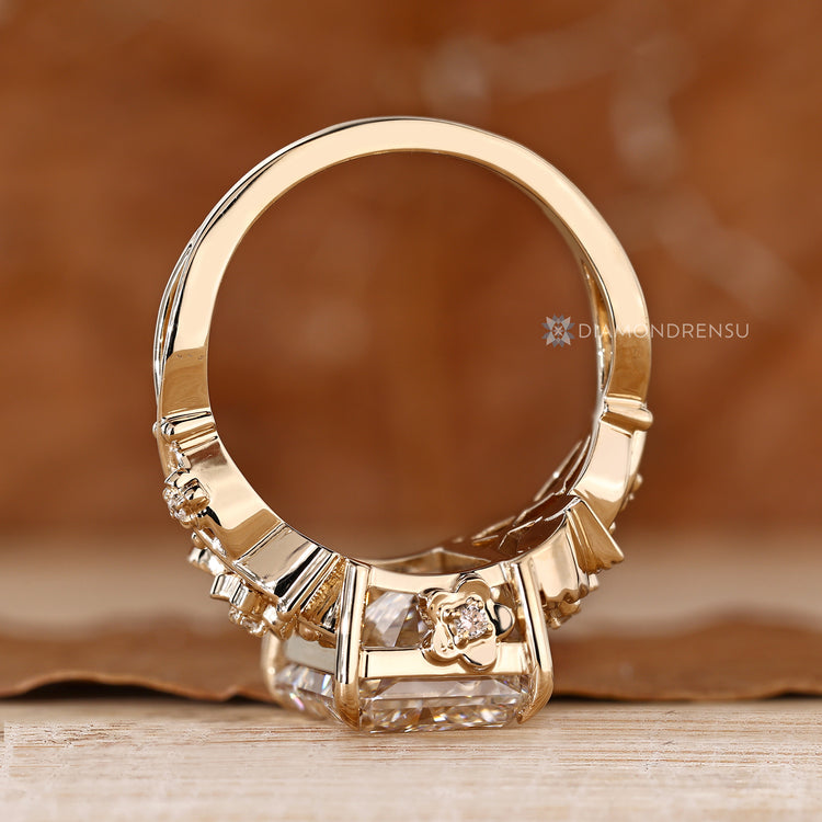 Floral radiant diamond ring with four claw prong setting.