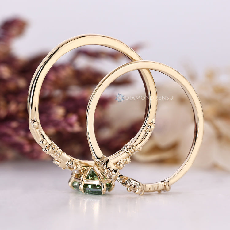 Green Dutch marquise diamond with six leaf style prong setting.