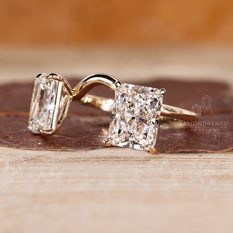 Radiant cut engagement ring with two stone curved band.