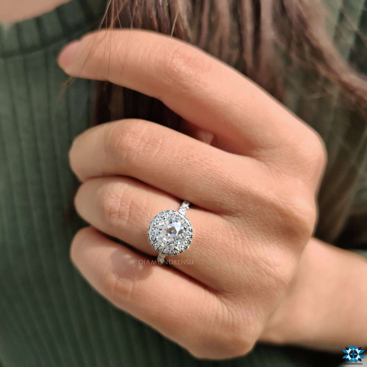Hidden halo engagement ring featuring a vintage round center stone.
