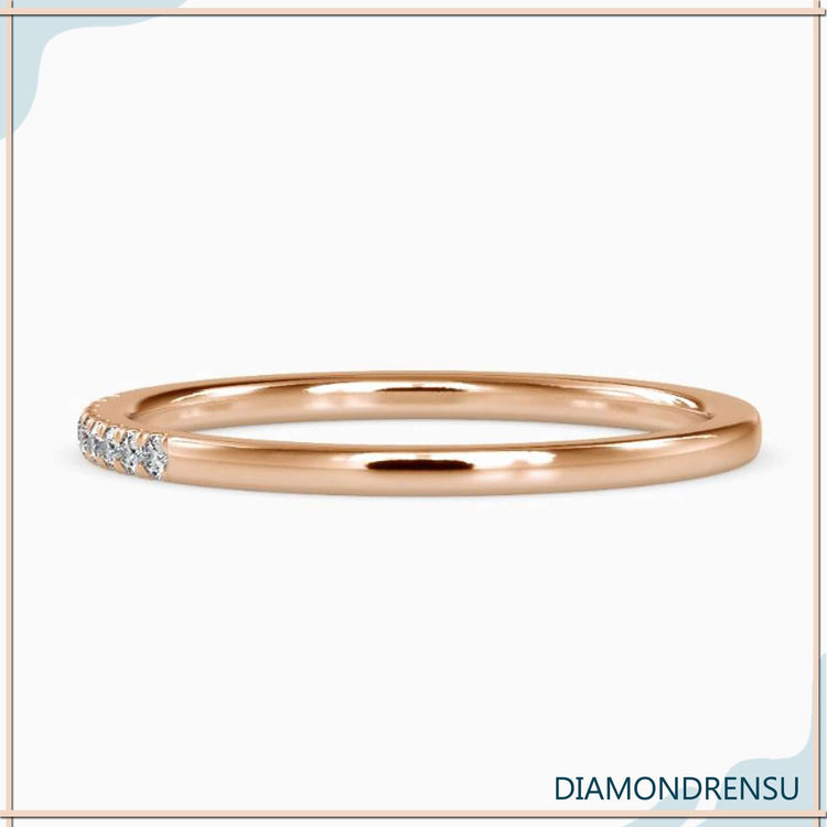 White gold wedding band featuring 1/4 eternity diamond row.
