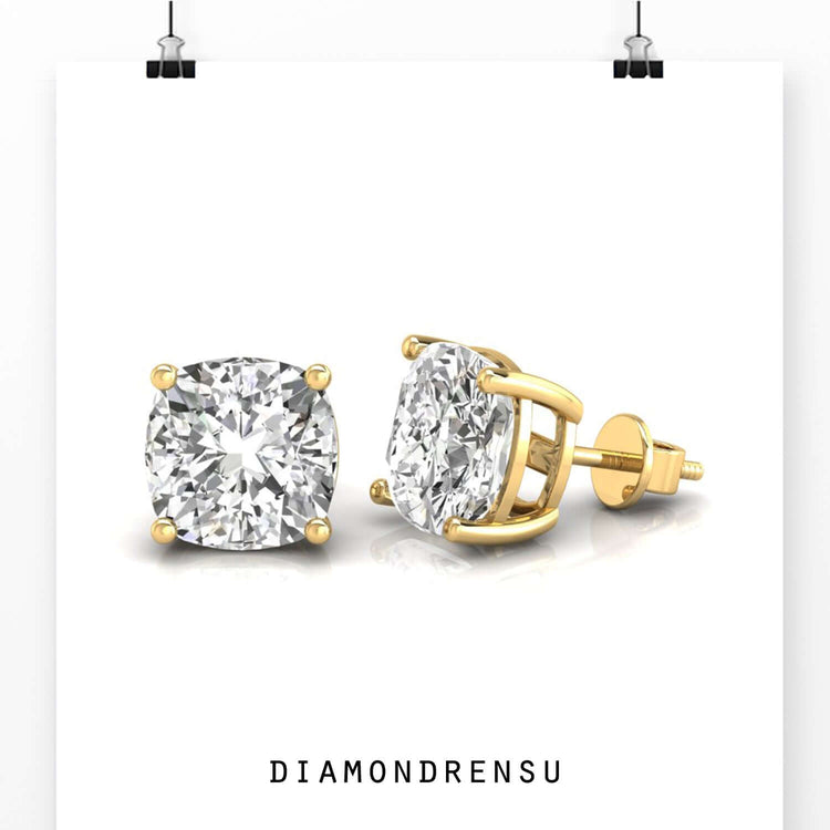 White gold earrings with cushion cut centre stones.
