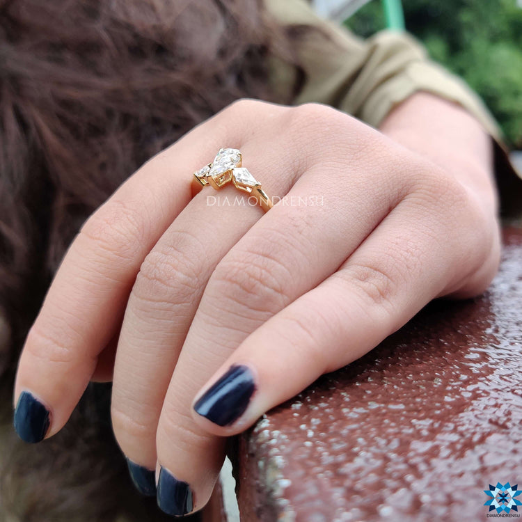 Prong setting ring with spear cut moissanite center.
