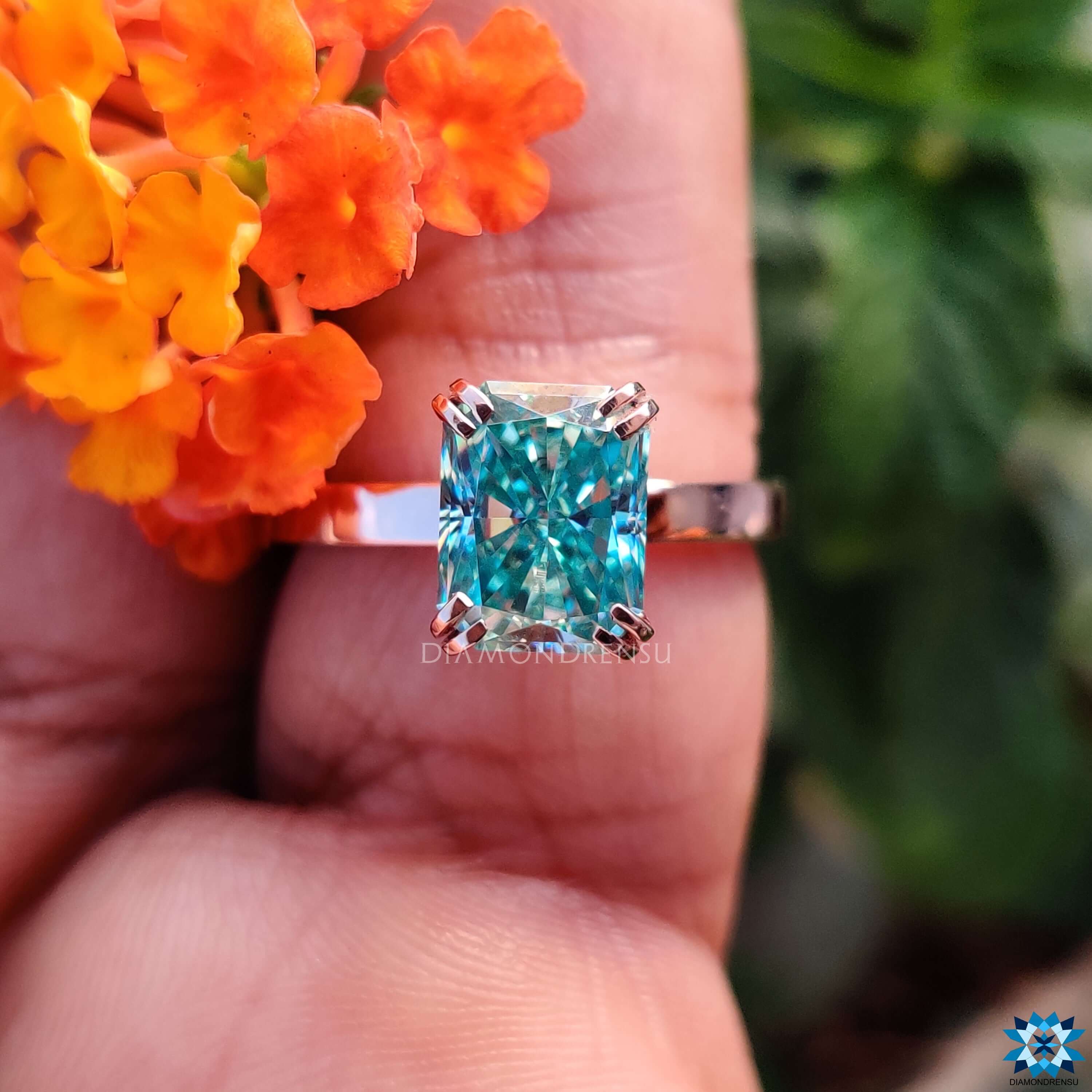 Rose Gold Moissanite Ring with a stunning blue centre stone for added elegance.