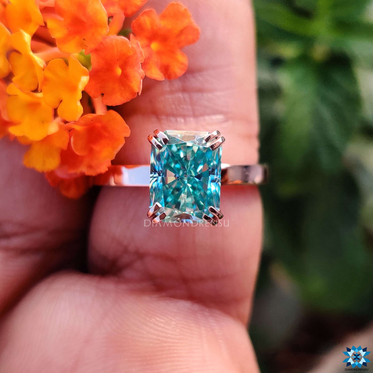 Rose Gold Moissanite Ring with a stunning blue centre stone for added elegance.