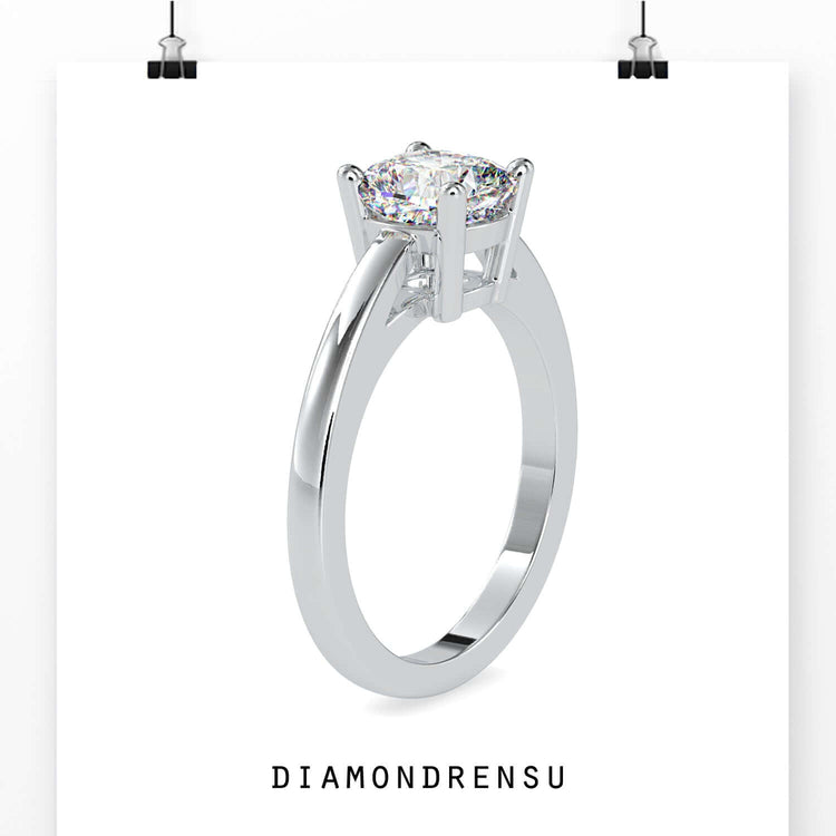 UK diamond ring featuring a cushion cut diamond in a 4 prong setting.
