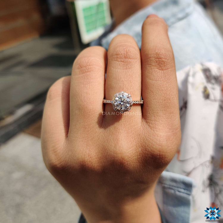 Round cut moissanite rose gold halo ring.
