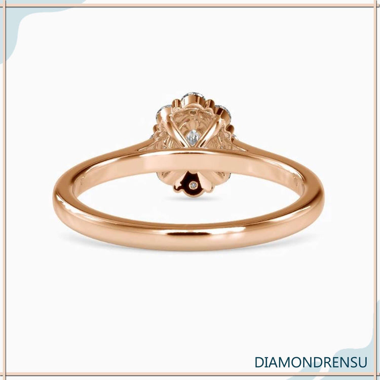 White gold oval diamond engagement ring with halo and prong mount.
