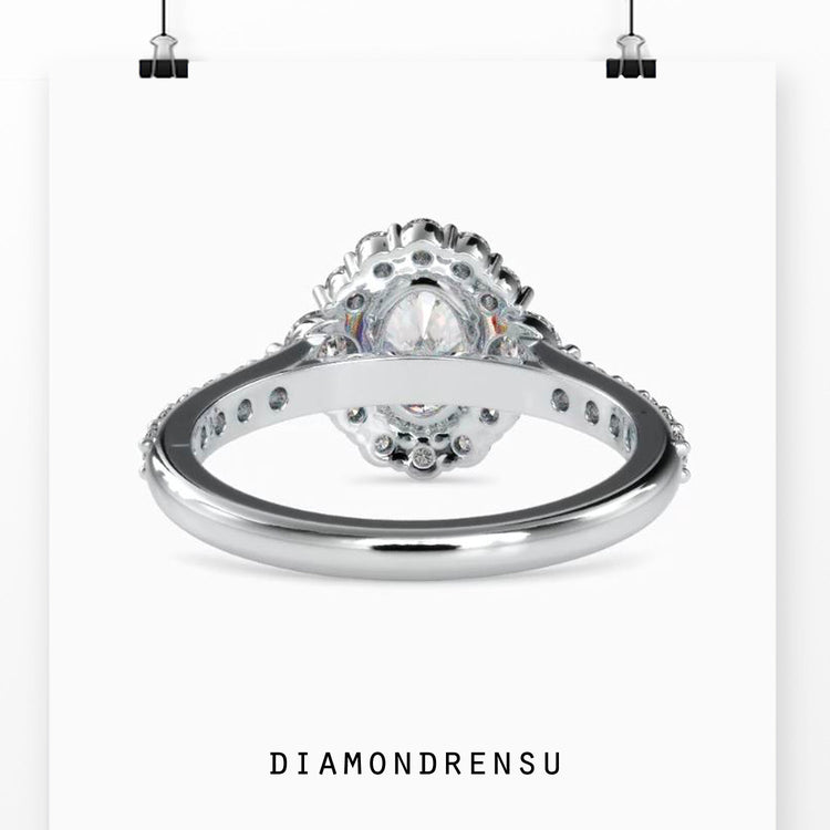 Custom design ring with cluster halo and oval centre diamond.
