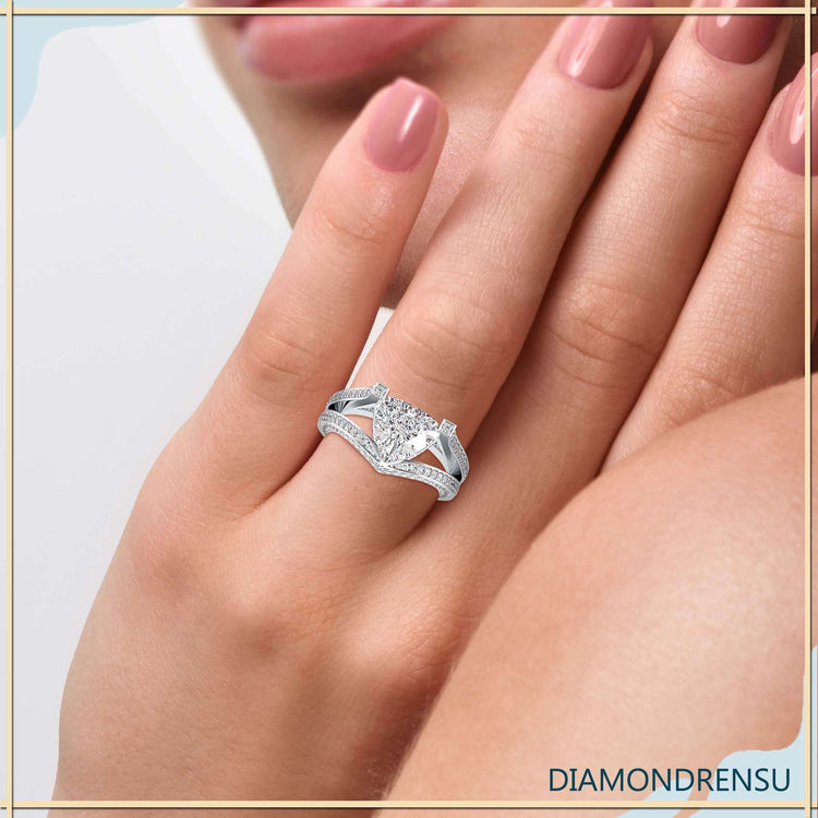 Split shank halo engagement ring with round side stones.

