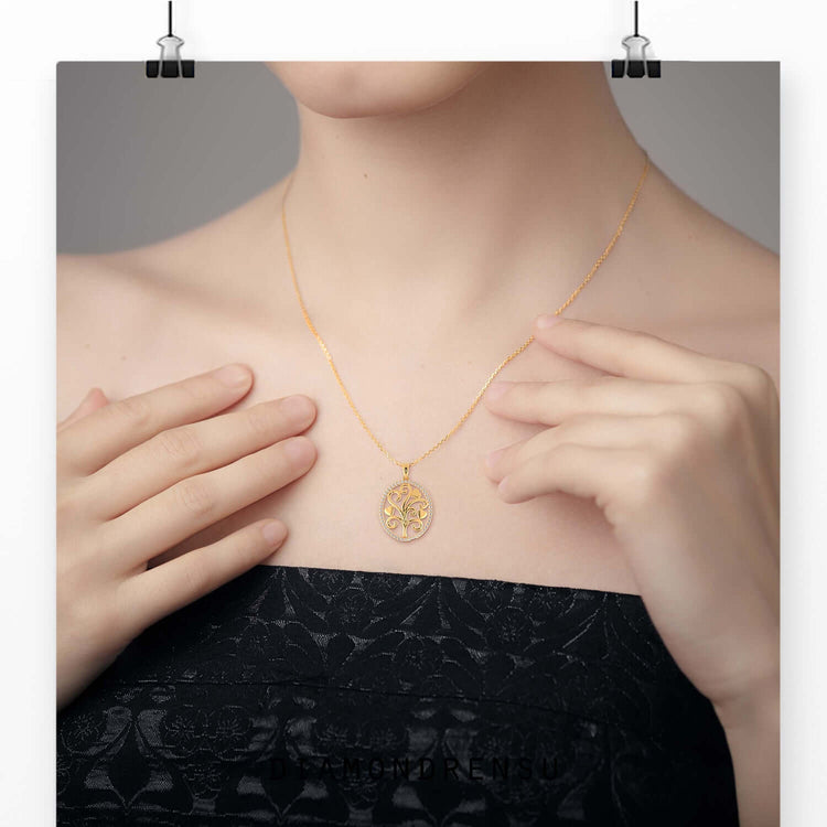 Oval shape outline pendant featuring a tree life design.
