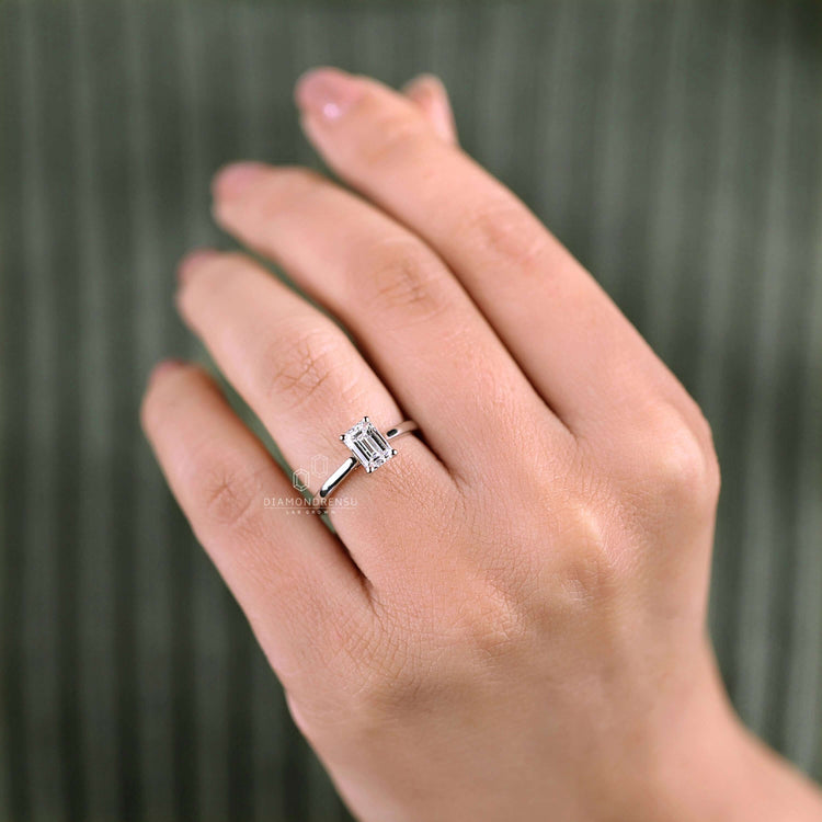 Pristine emerald solitaire ring with 4 prong ring setting.