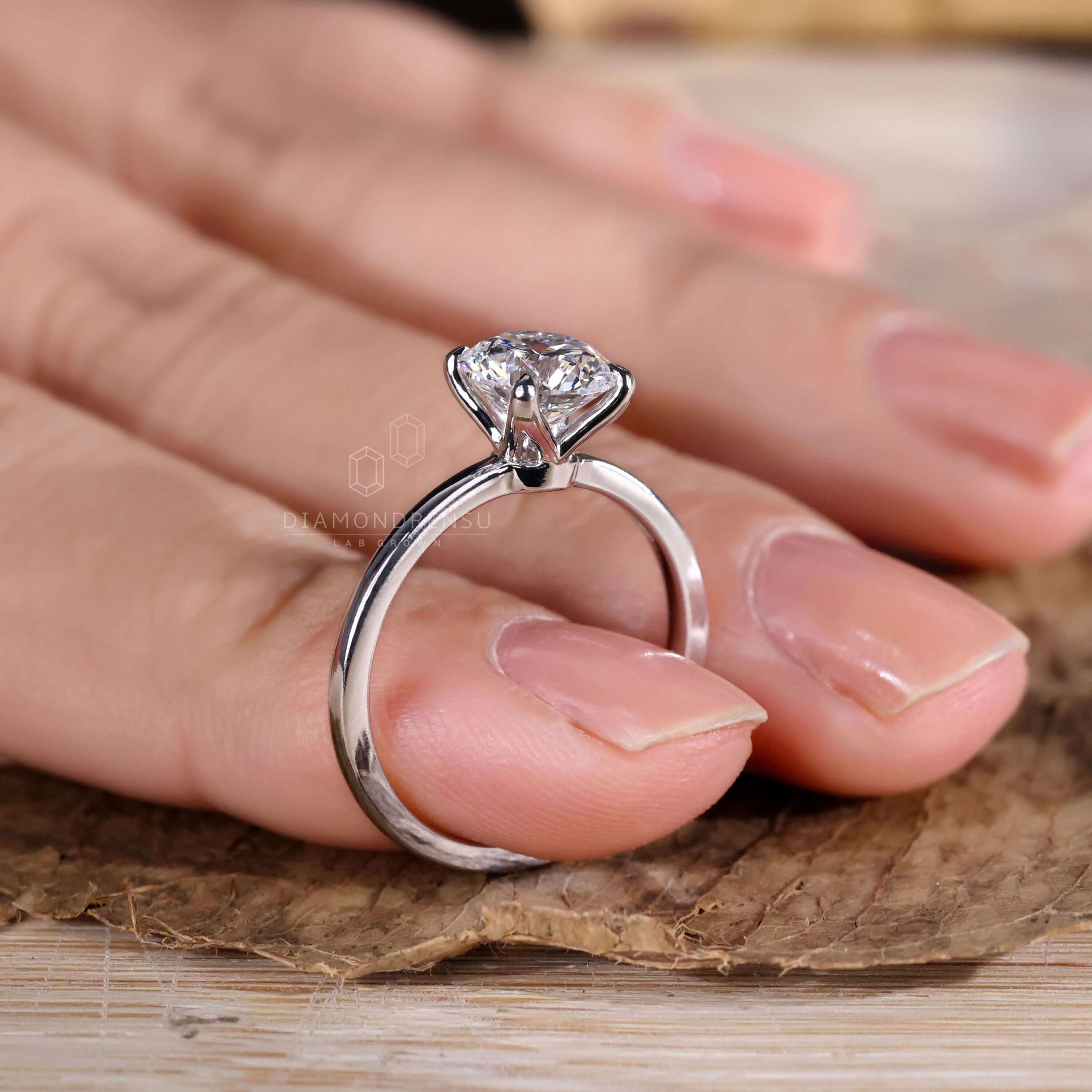 Round diamond engagement ring featuring a claw prong setting
