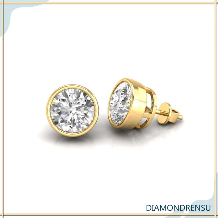 Rose gold diamond earrings in classic bezel style.
