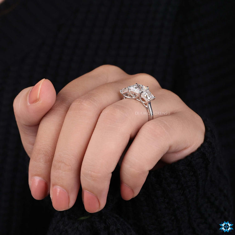 Trellis setting moissanite ring in a 3 stone layout.
