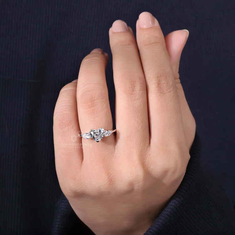 Heart and pear ring featuring two pear side stones for added sparkle.

