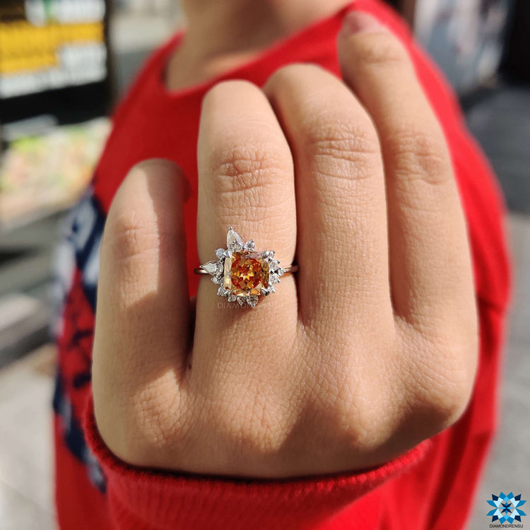 Elegant engagement ring with champagne moissanite and mixed side stones.
