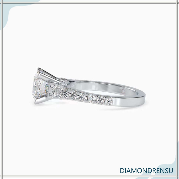 Custom engagement ring with round cut diamond and pave design.
