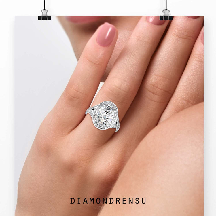 Oval cut diamond ring with tapered baguette halo.
