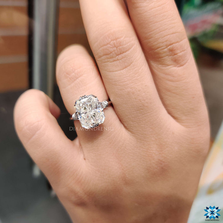 White gold ring with radiant center and milgrain detail.
